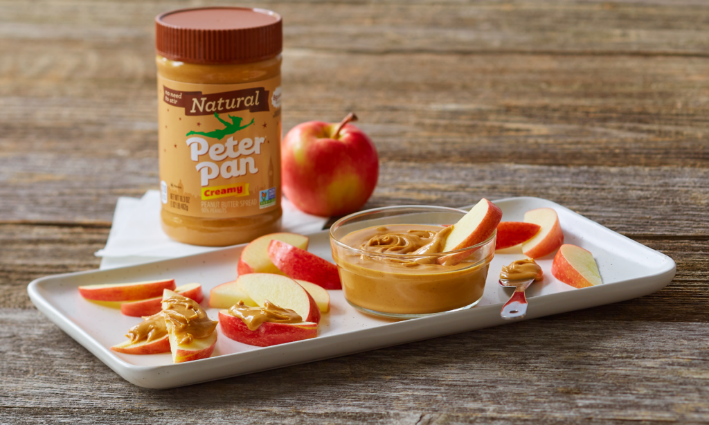 Peter Pan Natural Creamy Peanut Butter served with apple slices