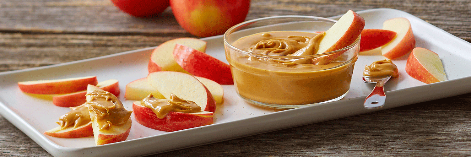 Natural Peter Pan Peanut Butter served with apple slices